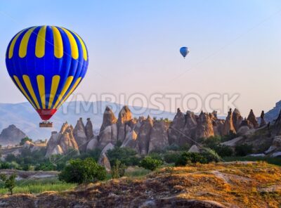 Cappadocia hot air balloon flying over bizarre rock landscape in Turkey