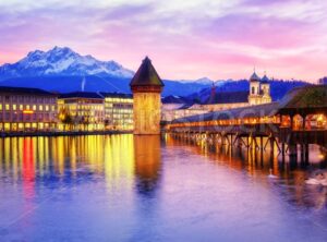 Chapel bridge, Water tower and Mount Pilatus on sunset, Lucerne, Switzerland.