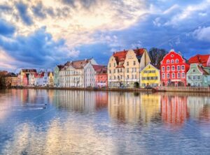 Colorful gothic houses reflecting in Isar river on sunset, Landshut, Munich, Germany