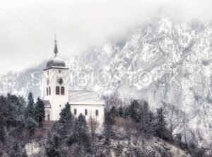 Cristian church on a snow covered hill in winter near Salzburg, Austria