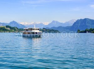 Cruise ship in front of Alps mountains peaks on Lake Lucerne, Switzerland