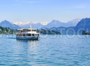 Cruise ship in front of Alps mountains peaks on Lake Lucerne, Switzerland