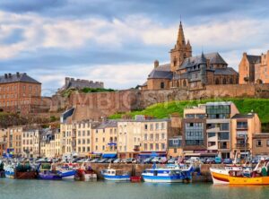 Gothic church on the hill and fishermen boats in port town Granville, Normandy, France