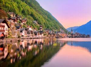 Hallstatt town reflecting in the lake on sunset, Salzkammergut, Austria