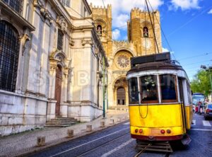 Historical yellow tram in front of the Lisbon cathedral, Lisbon, Portugal