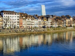 Houses along the Rhine river with Roche Tower in background, Basel, Switzerland