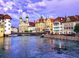 Lucerne, Switzerland, on sunset. View over Reuss river to Jesuit Church