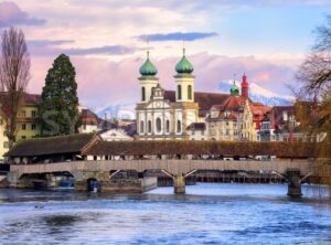 Lucerne, Switzerland, view over the Reuss river to the wooden Spreuer Bridge, Jesuit Church and the Old Town