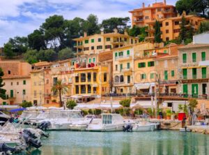 Motor boats and traditional houses in Puerto Soller, Mallorca, Spain