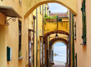 Narrow street leading to the Mediterranean Sea in old town Varigotti, Liguria, Italy