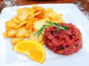 Steak tartare served with french fries potato chips