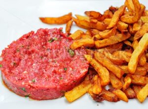 Steak tartare served with french fries potato chips