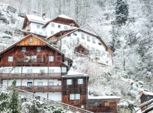 Traditional wooden houses on a hill slope in Alps mountains, Hallstatt, Austria