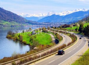 Swiss landscape with a highway, lake and mountains