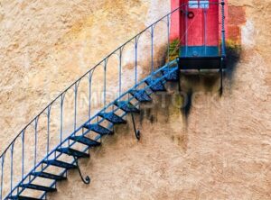 Decorated stairs leading to a door in terracotta wall - GlobePhotos - royalty free stock images