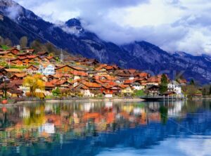 Old town and Alps mountains reflecting in lake, Switzerland - GlobePhotos - royalty free stock images