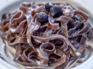 Blueberry tagliatelle pasta with cream sauce, italian cuisine - GlobePhotos - royalty free stock images