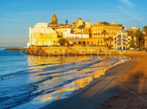 Sand beach and historical Old Town in mediterranean resort Sitges, Spain - GlobePhotos - royalty free stock images