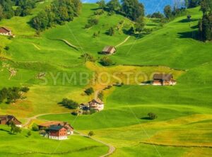 Idyllic green meadows and Alps mountains landscape, Switzerland - GlobePhotos - royalty free stock images