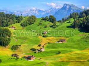 Idyllic green meadows and Alps mountains landscape, Switzerland - GlobePhotos - royalty free stock images