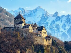 Vaduz Castle, Liechtenstein, with snow covered Alps mountains in background - GlobePhotos - royalty free stock images