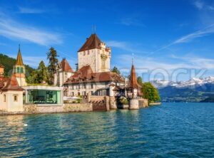 Oberhofen castle an Alps mountains, Lake Thun, Switzerland