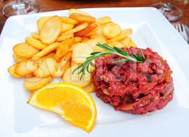 Steak tartare served with french fries potato chips Stock Photo