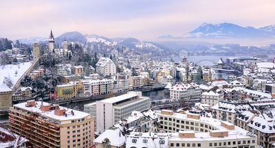 Lucerne, Switzerland, view of the old town, city wall towers, and Alps mountains Stock Photo