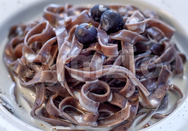 Blueberry tagliatelle pasta with cream sauce, italian cuisine Stock Photo