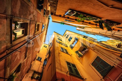 Traditional houses in a narrow street in Genoa, Italy Stock Photo