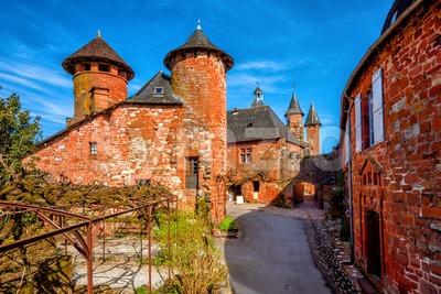Collonges-la-Rouge, red brick houses and towerd of the Old Town, France Stock Photo