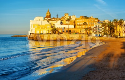 Sand beach and historical Old Town in mediterranean resort Sitges, Spain Stock Photo