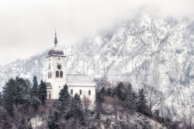 Cristian church on a snow covered hill in winter near Salzburg, Austria Stock Photo
