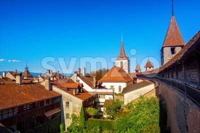 Red tiled roofs and wall towers in Old Town Murten, Switzerland Stock Photo