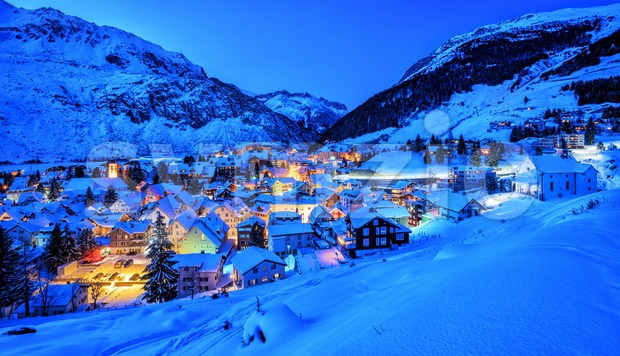 Andermatt village in Alps mountains in winter snow, Uri, Switzerland Stock Photo