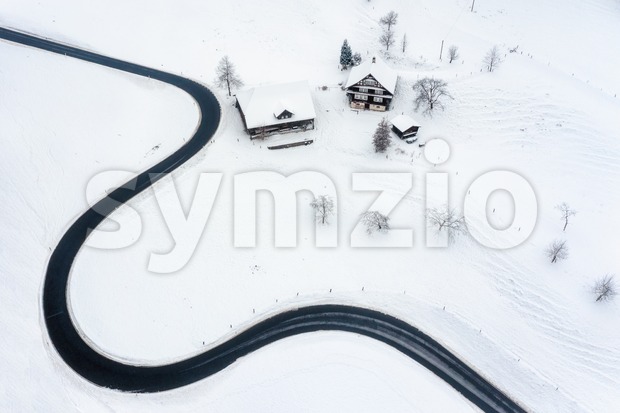 Road winding in the swiss Alps mountains in winter time Stock Photo
